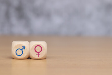 Male and female symbols on wooden cube. concept of gender equality