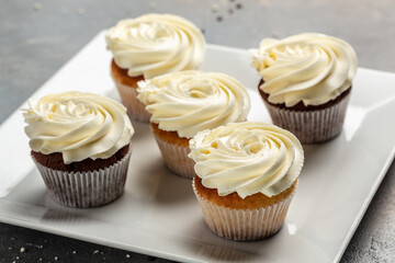 Cupcakes or muffins with cream. Holiday cake celebration, delicious dessert, close up