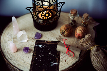 Witch altar to perform rituals with crystals, two walnuts, a scroll with a spell and tarot cards.. - obrazy, fototapety, plakaty