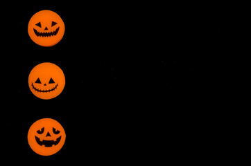 Three variants of the Jack-o-lantern on a black background. The Halloween symbol. Orange and black colors, minimalism.