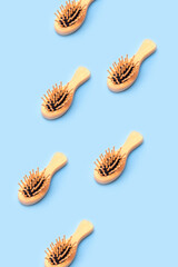 Pattern of wooden combs on a blue background. Creative concept