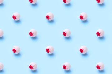 Halloween pattern of bloody eyeball on a blue background
