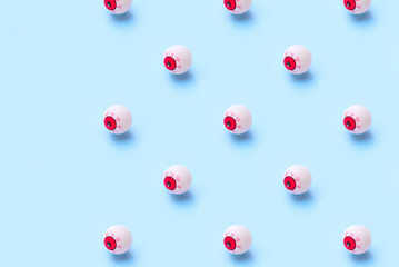 Halloween pattern of bloody eyeball on a blue background

