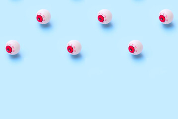 Halloween pattern of bloody eyeball on a blue background
