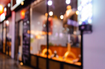 Blurred abstract view of a suit shop in a night market with no people during the coronavirus pandemic.