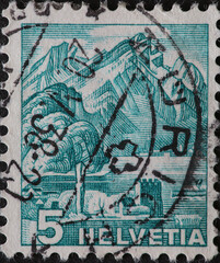 Switzerland - Circa 1936: a postage stamp printed in the Switzerland showing a permanent series with the Swiss landscape with a castle and the Pilatus mountains seen from Stansstad