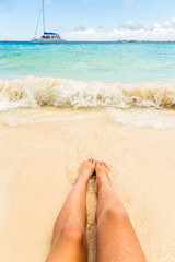 Female legs on the beach
