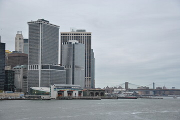 new york city skyline cityscape with statue of liberty over hudson river. with midtown Manhattan...