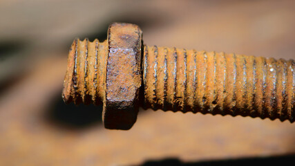 old rusty bolt, iron rod with screw threads. Rusted mechanical components. threaded bolt and nut isolated close up. dismantling concept, difficult to unscrew, non-removable. selective focus