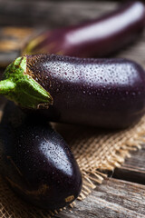 Raw purple eggplant. Fresh aubergine on wooden background