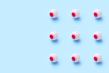 Halloween pattern of bloody eyeball on a blue background
