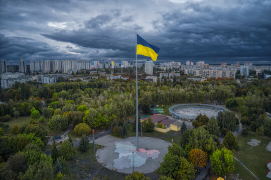Closeup shot of Ukrainian Flag in Brovary Park with dramatic clouds and cold  weather