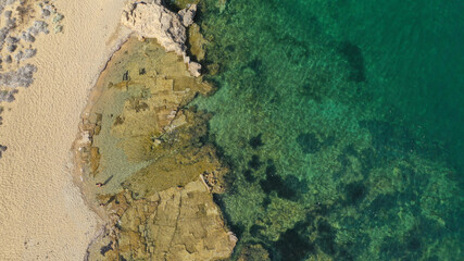 Aerial drone photo of small bay and sandy beach of Pouria with strange rock formations in island of Skyros, Sporades, Greece