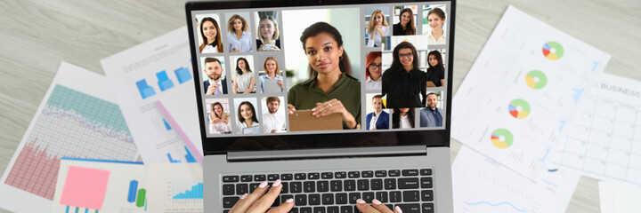 Woman sitting on floor near documents and communicating via video link with team of employees top view
