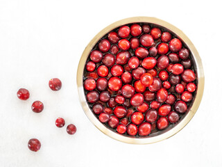 red cranberries floating in water in metal bowl