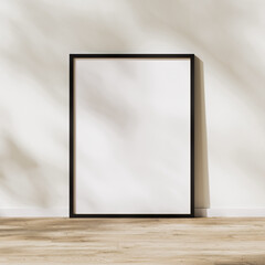 blank vertical black frame mock up, poster frame on wooden floor with sunlight with leaves shadow on white wall, 3d rendering