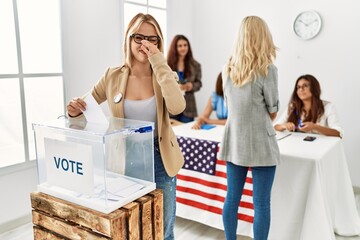 Group of young girls voting at democracy referendum smelling something stinky and disgusting, intolerable smell, holding breath with fingers on nose. bad smell - obrazy, fototapety, plakaty