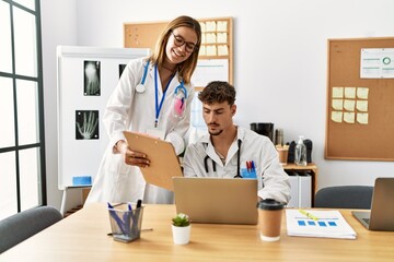 Two hispanic doctor working in a medical meeting at the clinic office.