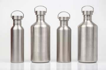 metal steel water flasks on white background. metal drinking utensils