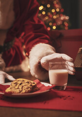 Santa Claus having a delicious snack