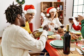 Group of young people smiling happy having christmas dinner at home.