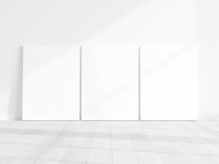 three vertical canvases mockup on the floor