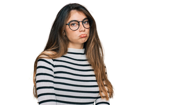 Young beautiful teen girl wearing casual clothes and glasses depressed and worry for distress, crying angry and afraid. sad expression.
