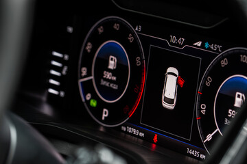 Color detail of an error message on a car dashboard. Door opened alarm. Warning light.