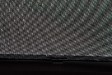 Opened sunshade. Car side window curtains sunshades. Sunblind curtain in a modern car.