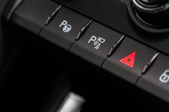 Hand operating ESP (electronic stability program) control close up view. Interior detail of a modern car. ESP button.
