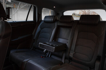 Folding seats and a cargo space inside suv car. Modern car interior. Huge, clean and empty car trunk.