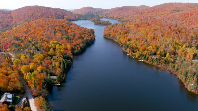 4K camera drone captures stunning autumn foliage colors and secluded lake houses.
