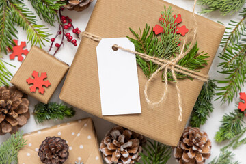 Christmas present with blank gift tag and decorations, Mockup