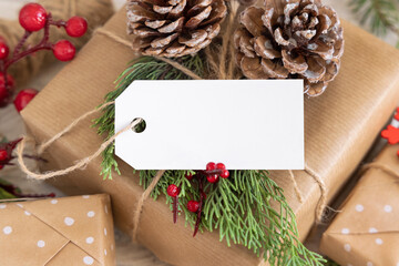 Christmas present with blank gift tag and decorations, Mockup