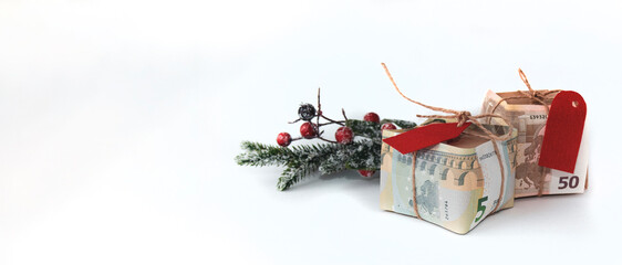 Money as a gift for the New Year and Christmas on a white background. An isolated image.
