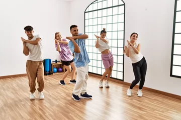 Washable wall murals Dance School Group of young dancer smiling happy dancing choreography at dance academy.