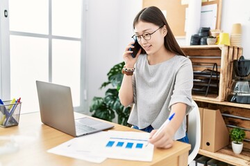 Young asian woman on a work call at the office