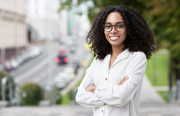 Young beautiful woman portrait, African american student girl in a city, Young businesswoman...