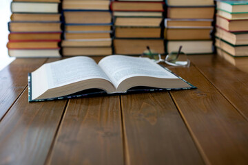 Open book, glasses on the table.