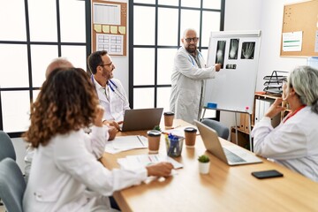 Group of middle age doctor discussing in a medical meeting at the clinic office.