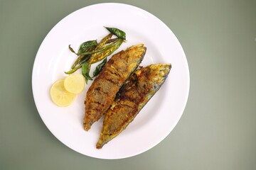 Indian Mackerel fish fry. Bangda Rava fry. whole Fried fish served on a banana leaf with fried...