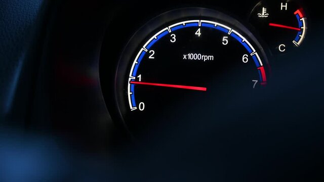 Car tachometer closeup and moving pointer on it.