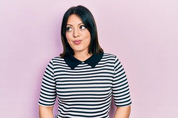 Fototapeta premium Young hispanic woman wearing casual clothes smiling looking to the side and staring away thinking.