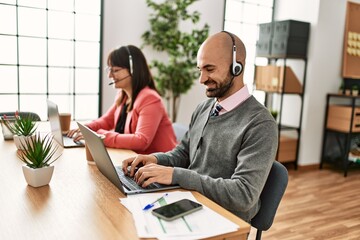 Two call center agent smiling happy working at the office.