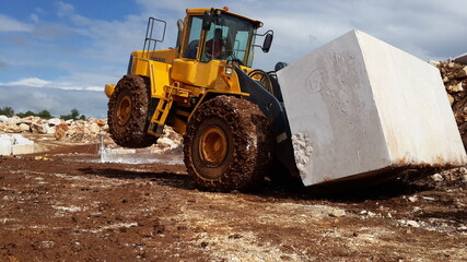 Loader Machine loading block marble at marble qaurry.