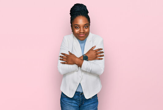 Young african american woman wearing business clothes shaking and freezing for winter cold with sad and shock expression on face