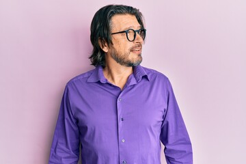 Middle age handsome man wearing casual clothes and glasses looking to side, relax profile pose with natural face and confident smile.