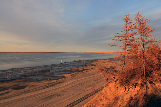 Autumn landscape on the northern river Khatanga in the evening at sunset hours.