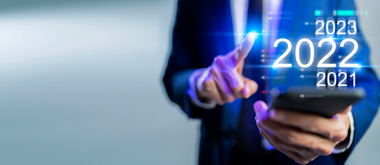 Business man press finger on  mobile phone, company corporate management data dashboard data analytics, sale, performance, productivity, KPI. Business  information technology 2022 new year concept