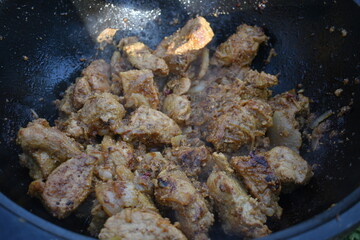 meat in a cauldron on fire